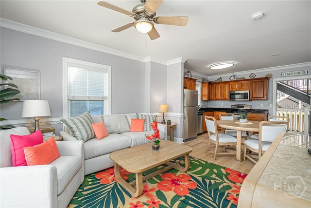 18 Silver Ave Unit 1, Tybee Island, GA 31328 - living room featuring ornamental molding, healthy amount of natural light, light wood-type flooring, and a ceiling fan