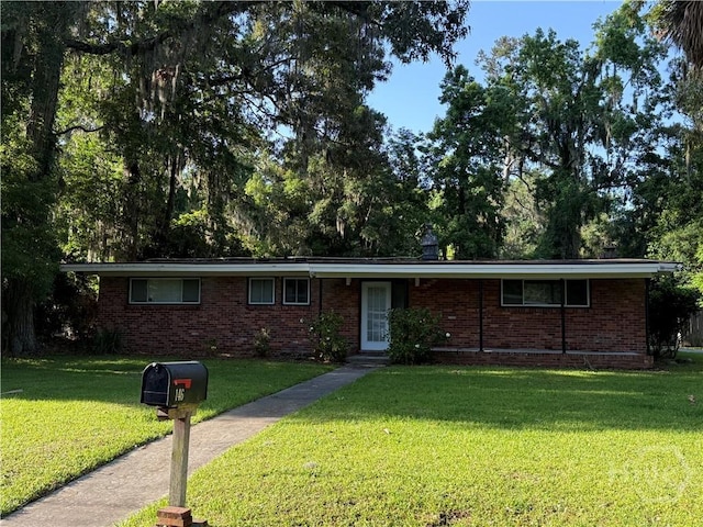 single story home featuring a front lawn and brick siding