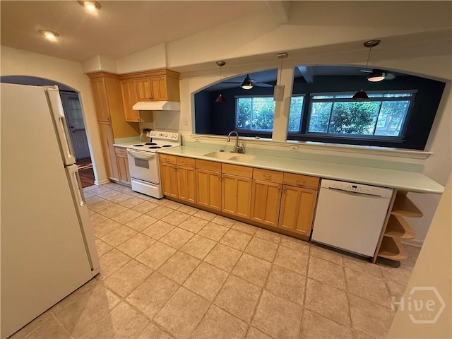 kitchen featuring white appliances, a sink, under cabinet range hood, light countertops, and light tile patterned floors
