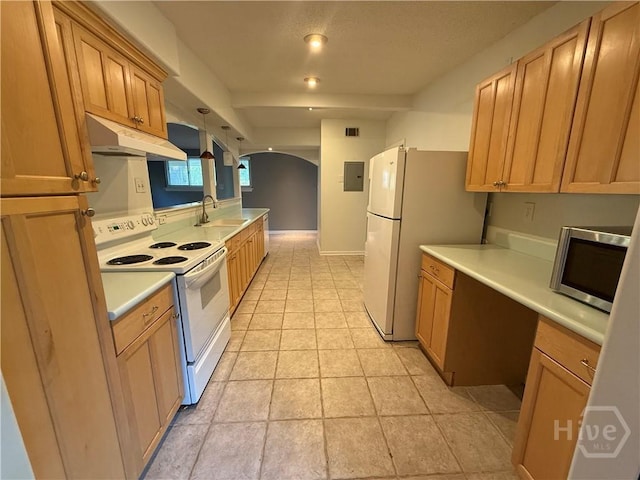 kitchen with white appliances, under cabinet range hood, arched walkways, a sink, and light countertops