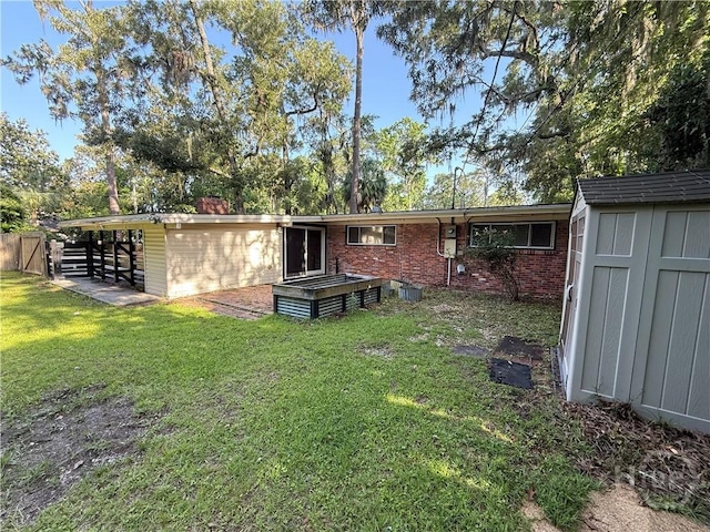 rear view of property with brick siding, an outdoor structure, a shed, and a yard
