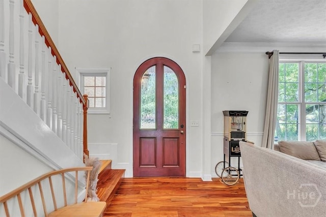 473 Kolic Helmey Rd, Guyton, GA 31312 - entryway featuring light wood-style floors, stairway, ornamental molding, a high ceiling, and baseboards
