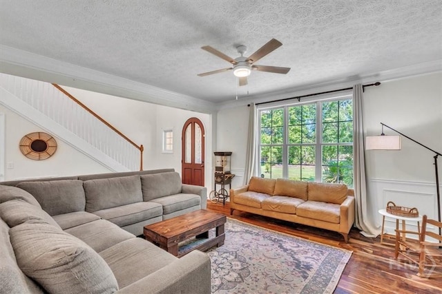 473 Kolic Helmey Rd, Guyton, GA 31312 - living area featuring hardwood / wood-style floors, a ceiling fan, a textured ceiling, ornamental molding, and stairs