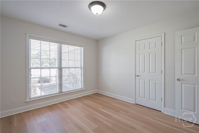 110 Pembroke Pl, Pembroke, GA 31321 - unfurnished bedroom with a textured ceiling, light wood-type flooring, and baseboards