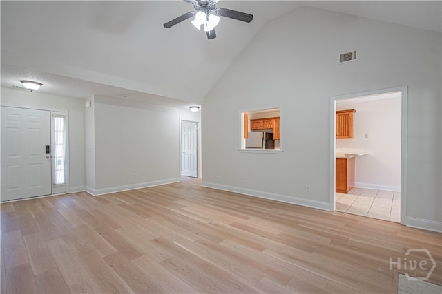 110 Pembroke Pl, Pembroke, GA 31321 - unfurnished living room with high vaulted ceiling, light wood finished floors, a ceiling fan, and baseboards