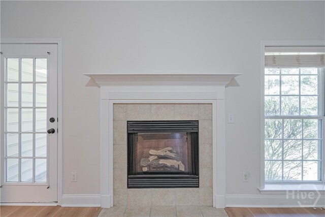 110 Pembroke Pl, Pembroke, GA 31321 - detailed view of baseboards, a tile fireplace, and wood finished floors