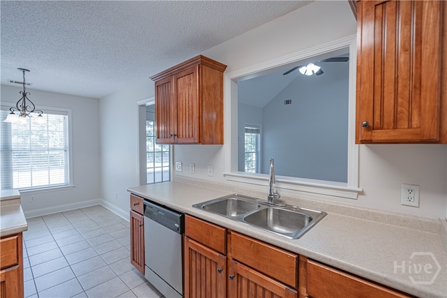 110 Pembroke Pl, Pembroke, GA 31321 - kitchen featuring stainless steel dishwasher, a sink, brown cabinetry, light countertops, and plenty of natural light