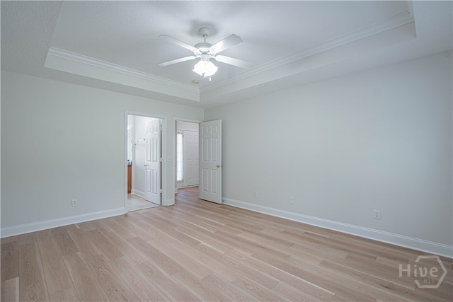 110 Pembroke Pl, Pembroke, GA 31321 - empty room with a tray ceiling, crown molding, ceiling fan, light wood finished floors, and baseboards