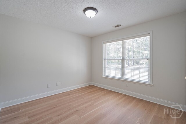 110 Pembroke Pl, Pembroke, GA 31321 - spare room featuring light wood-style flooring, baseboards, and a textured ceiling
