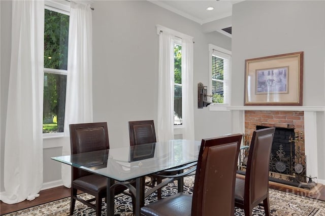 835 E Duffy St, Savannah, GA 31401 - dining space featuring dark wood-type flooring, a brick fireplace, baseboards, and ornamental molding