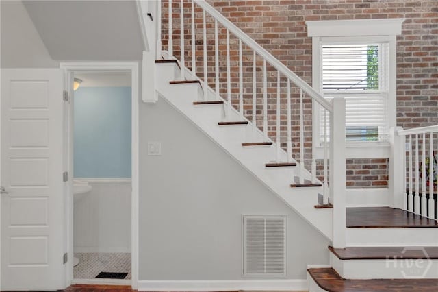 835 E Duffy St, Savannah, GA 31401 - stairway with brick wall and baseboards