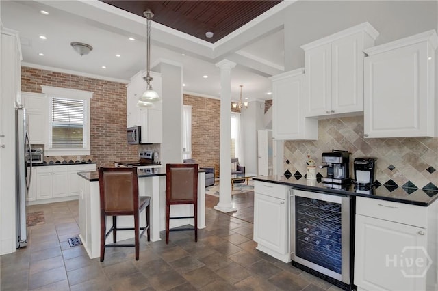 835 E Duffy St, Savannah, GA 31401 - kitchen with beverage cooler, dark countertops, appliances with stainless steel finishes, ornamental molding, and backsplash