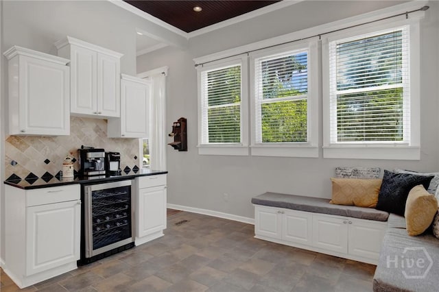 835 E Duffy St, Savannah, GA 31401 - kitchen featuring wine cooler, crown molding, dark countertops, backsplash, and baseboards