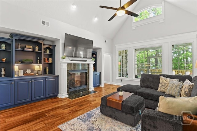2 Misty Marsh Ct, Savannah, GA 31419 - living area with a ceiling fan, wood finished floors, a tile fireplace, and high vaulted ceiling