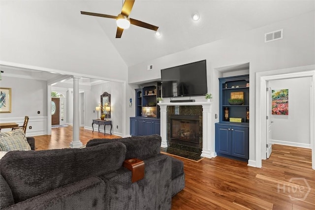 2 Misty Marsh Ct, Savannah, GA 31419 - living area featuring decorative columns, high vaulted ceiling, ceiling fan, a fireplace, and wood finished floors