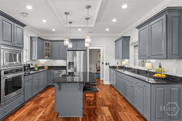 2 Misty Marsh Ct, Savannah, GA 31419 - kitchen with stainless steel appliances, gray cabinetry, a sink, a center island, and dark wood-type flooring