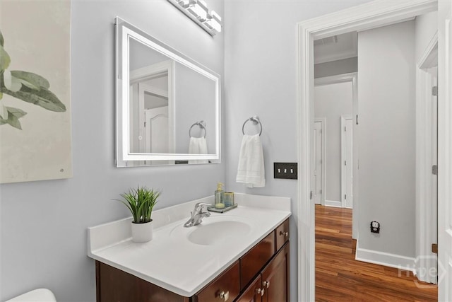 2 Misty Marsh Ct, Savannah, GA 31419 - half bathroom featuring wood finished floors, vanity, baseboards, and toilet