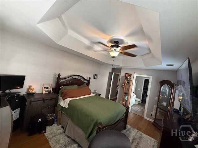 152 Junco Way, Savannah, GA 31419 - bedroom with a raised ceiling, wood finished floors, and a ceiling fan