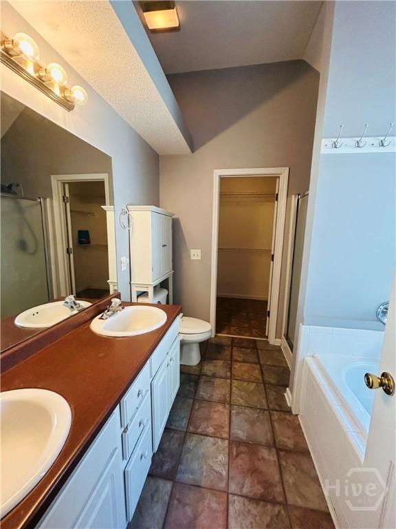 152 Junco Way, Savannah, GA 31419 - bathroom featuring a shower stall, stone finish floors, a garden tub, and double vanity