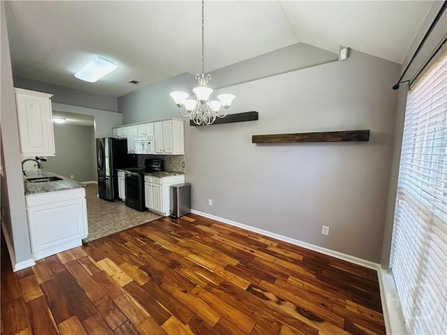 152 Junco Way, Savannah, GA 31419 - kitchen featuring black appliances, a sink, dark wood finished floors, a chandelier, and lofted ceiling