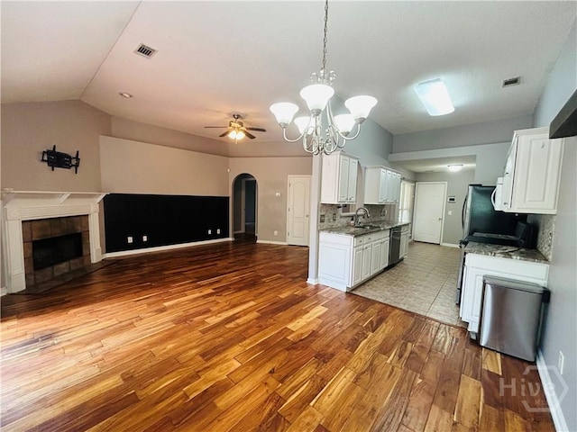 152 Junco Way, Savannah, GA 31419 - kitchen featuring open floor plan, wood finished floors, white cabinetry, a ceiling fan, and a fireplace