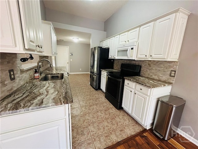 152 Junco Way, Savannah, GA 31419 - kitchen featuring white microwave, black range with electric cooktop, a sink, freestanding refrigerator, and white cabinets