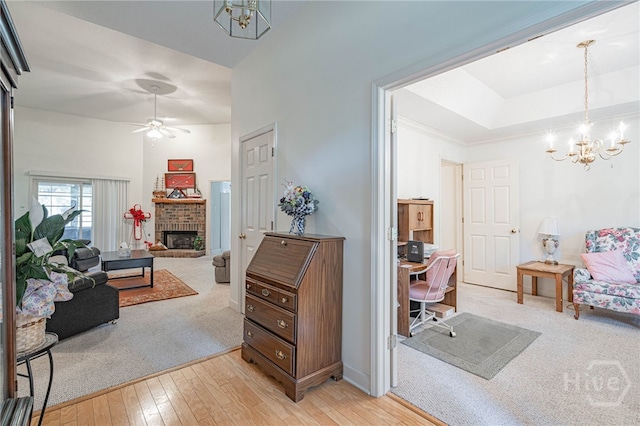 417 Willowpeg Way, Rincon, GA 31326 - living room with a chandelier, an office area, a brick fireplace, light wood-style flooring, and a ceiling fan