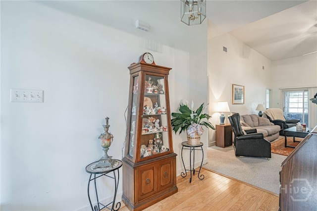417 Willowpeg Way, Rincon, GA 31326 - living area featuring wood finished floors, a towering ceiling, and baseboards