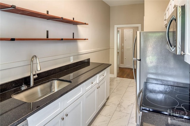 126 E 53rd St, Savannah, GA 31405 - kitchen featuring light marble finish floors, stainless steel microwave, open shelves, white cabinetry, and a sink