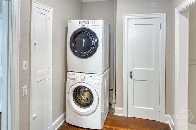 126 E 53rd St, Savannah, GA 31405 - laundry area with stacked washer and clothes dryer, dark wood-style floors, and baseboards
