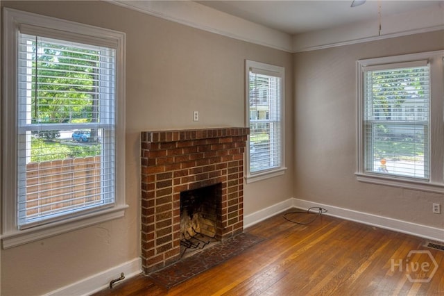126 E 53rd St, Savannah, GA 31405 - unfurnished living room with baseboards, wood finished floors, and plenty of natural light