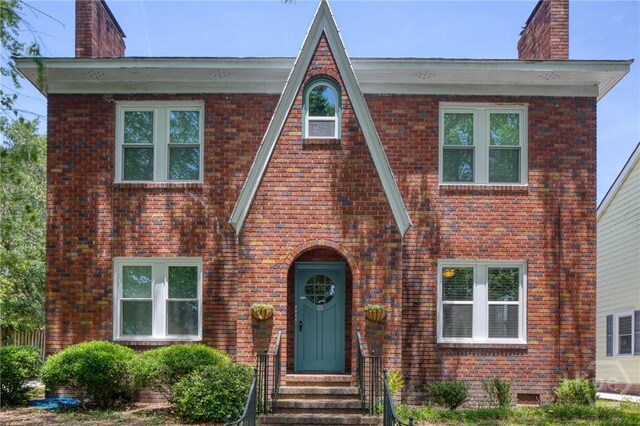 126 E 53rd St, Savannah, GA 31405 - view of front of house featuring a chimney, brick siding, and entry steps
