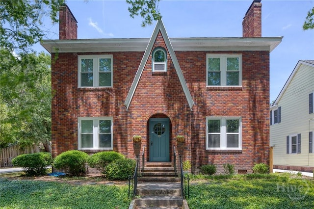 126 E 53rd St, Savannah, GA 31405 - view of front of house featuring a chimney, brick siding, fence, and entry steps