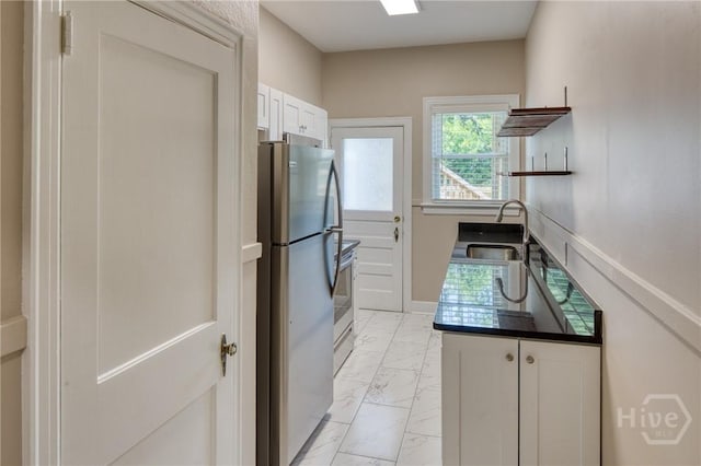 126 E 53rd St, Savannah, GA 31405 - kitchen featuring a sink, stainless steel appliances, light marble finish flooring, white cabinets, and open shelves