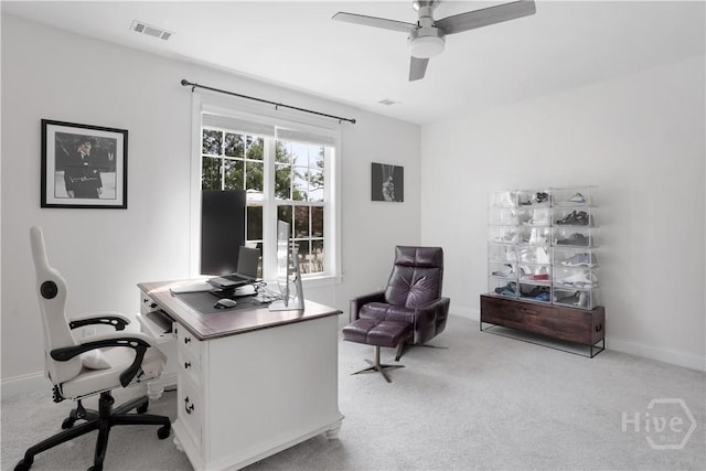 home office with light carpet, ceiling fan, and baseboards