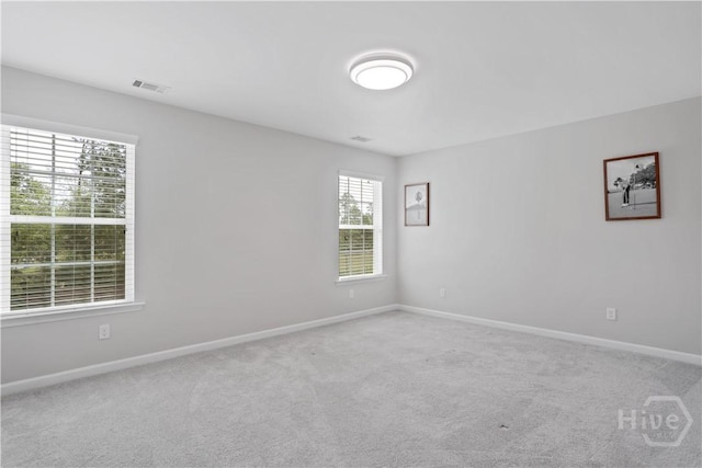 carpeted spare room with baseboards