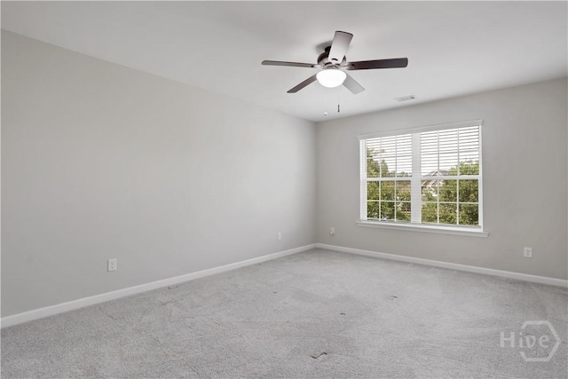 spare room featuring baseboards, carpet, and a ceiling fan