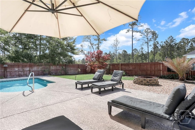 view of pool with an outdoor fire pit, a fenced backyard, and a patio area