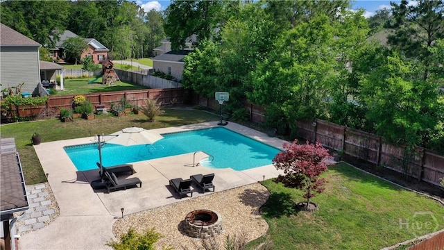 view of swimming pool featuring an outdoor fire pit, a patio area, and a playground