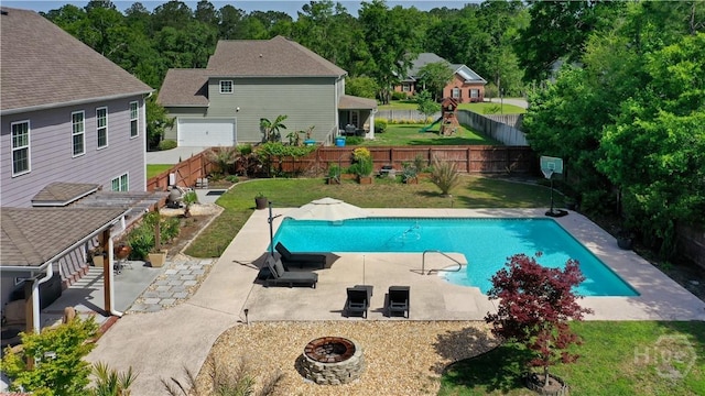 view of swimming pool featuring a fire pit and a patio