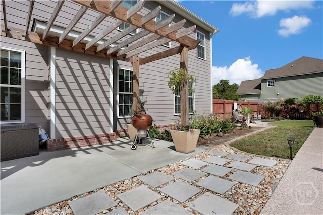 view of patio with a pergola and fence