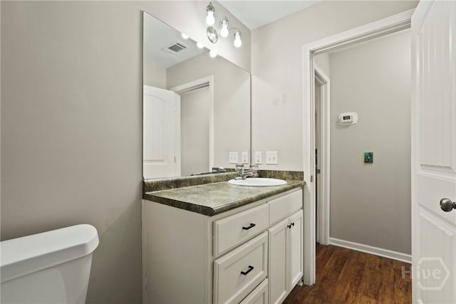 306 Madison Oaks Dr, Rincon, GA 31326 - bathroom featuring toilet, vanity, and wood finished floors