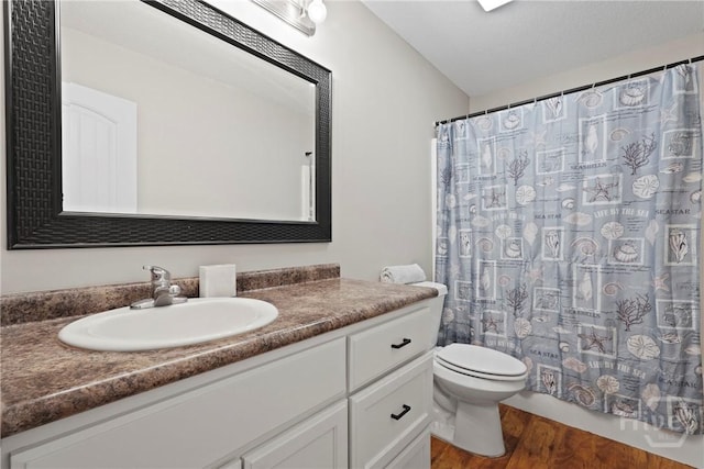 306 Madison Oaks Dr, Rincon, GA 31326 - full bathroom featuring wood finished floors, vanity, toilet, and curtained shower