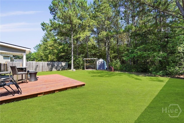 306 Madison Oaks Dr, Rincon, GA 31326 - view of yard featuring a storage shed, a deck, and an outbuilding