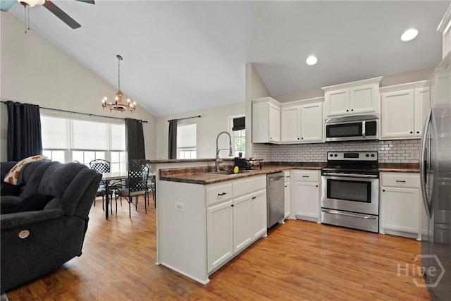 306 Madison Oaks Dr, Rincon, GA 31326 - kitchen featuring appliances with stainless steel finishes, a sink, a peninsula, a chandelier, and ceiling fan
