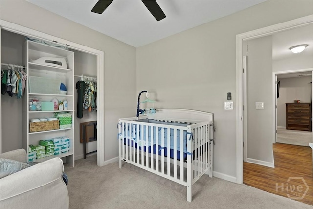 306 Madison Oaks Dr, Rincon, GA 31326 - carpeted bedroom featuring a crib, baseboards, and ceiling fan
