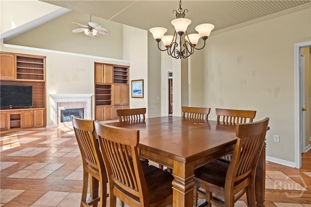 303 Stonebridge Cir, Savannah, GA 31419 - dining space with a high ceiling, a fireplace, a chandelier, baseboards, and ceiling fan