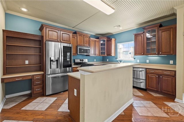 303 Stonebridge Cir, Savannah, GA 31419 - kitchen featuring stainless steel appliances, crown molding, light countertops, glass insert cabinets, and light wood-type flooring