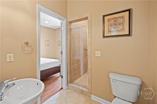 303 Stonebridge Cir, Savannah, GA 31419 - bathroom featuring a sink, a stall shower, tile patterned floors, toilet, and ensuite bathroom