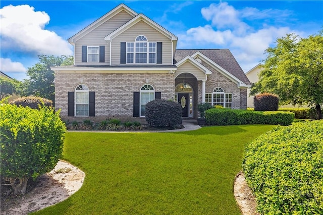 303 Stonebridge Cir, Savannah, GA 31419 - traditional-style house with brick siding and a front yard